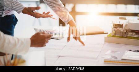 Cropped shot of professional architect  and engineer discussing on the construction plan together Stock Photo