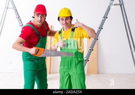 Two workers contractors working indoors Stock Photo