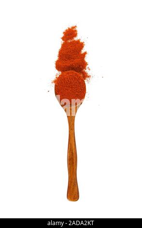 Paprika in a wooden spoon on isolate. View from above. Spice in the spoon. Priprva on isolate. Stock Photo
