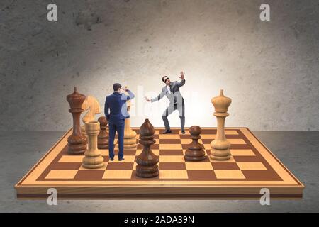 Businessman in large chess board in strategy concept Stock Photo