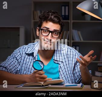 Student preparing for exams late night at home Stock Photo