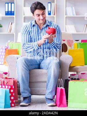 Young man after excessive shopping at home Stock Photo