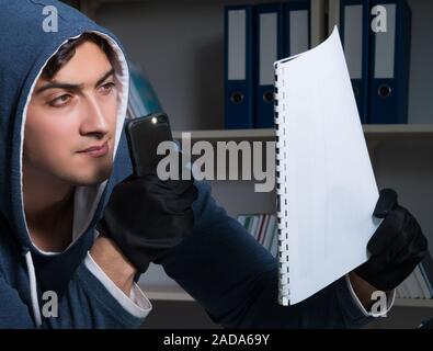 Young man in industrial espionage concept Stock Photo