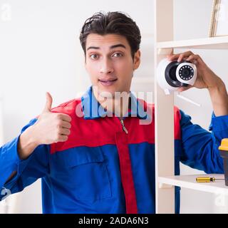 Client getting securty camera installed at home by contractor Stock Photo