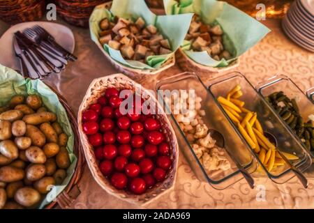 typical side dishes for swiss cheese fondue with bred, potatoes and more, dinner Stock Photo