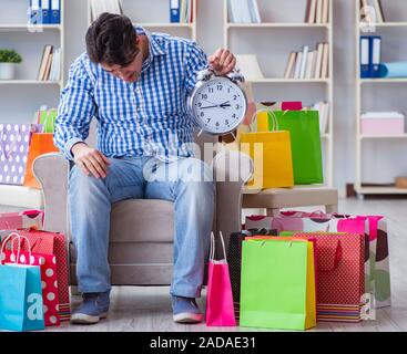 Young man after excessive shopping at home Stock Photo