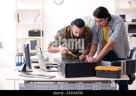 IT engineers working on hardware issue Stock Photo