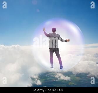 Businessman flying inside the bubble Stock Photo