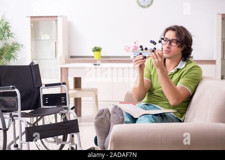 Young male student in wheelchair at home Stock Photo