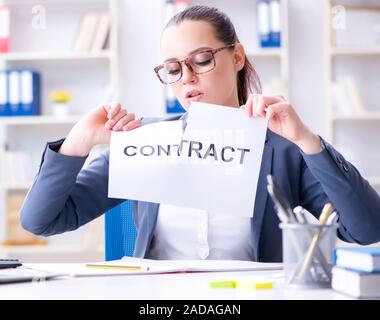 Businesswoman tearing apart her contract Stock Photo - Alamy