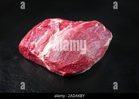 Raw dry aged wagyu silverside with eye of round piece as closeup on black background with copy space Stock Photo