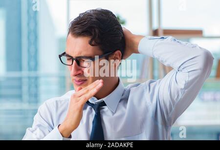 Businessman suffering from excessive armpit sweating Stock Photo