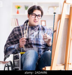 Disabled artist painting picture in studio Stock Photo