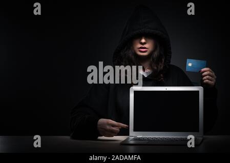 Female hacker hacking security firewall late in office Stock Photo