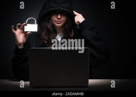 Female hacker hacking security firewall late in office Stock Photo