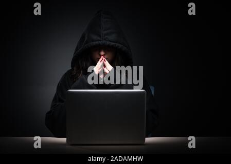 Female hacker hacking security firewall late in office Stock Photo