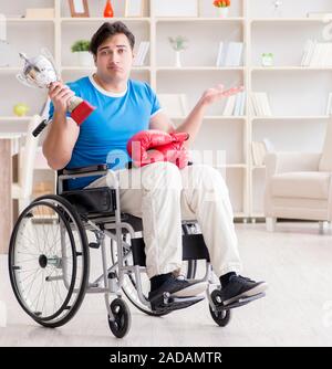 Disabled boxer at wheelchair recovering from injury Stock Photo