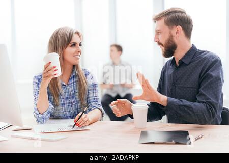 young employees discussing something during the coffee break. office weekdays Stock Photo