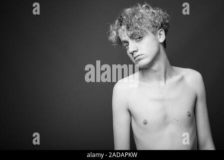 Skinny Young Man With Curly Hair Shirtless In Black And White
