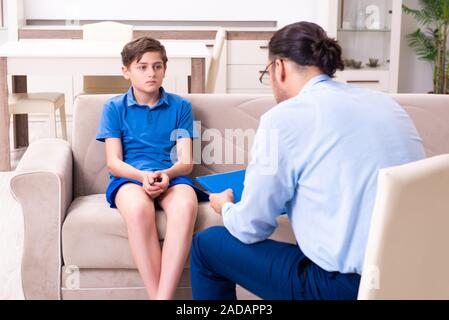 Internet addicted boy visiting male doctor Stock Photo