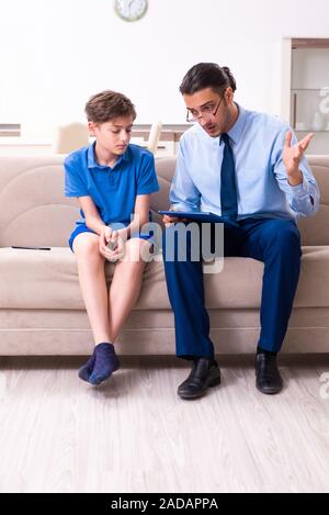 Internet addicted boy visiting male doctor Stock Photo