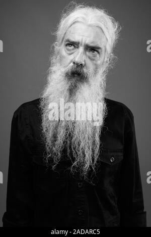 Senior man with long hair and beard in black and white Stock Photo