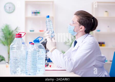 Young male chemist experimenting in lab Stock Photo