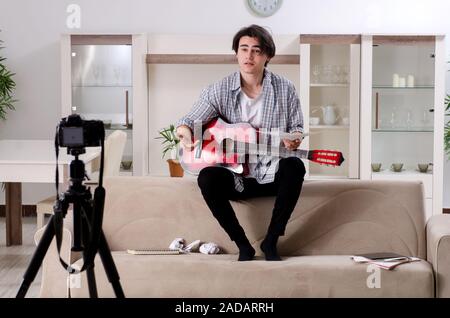 Young guitar player recording video for his blog Stock Photo