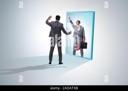Businessman seeing himself in mirror as superhero Stock Photo - Alamy