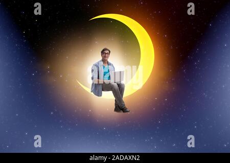 Student working on laptop on the moon crescent Stock Photo