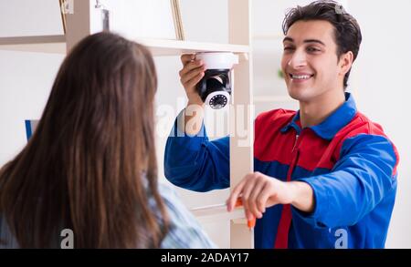 Client getting securty camera installed at home by contractor Stock Photo