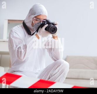 Forensic expert at crime scene doing investigation Stock Photo