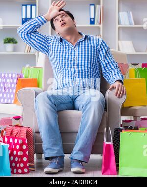 Young man after excessive shopping at home Stock Photo