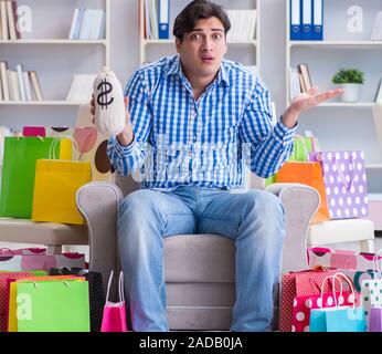 Young man after excessive shopping at home Stock Photo