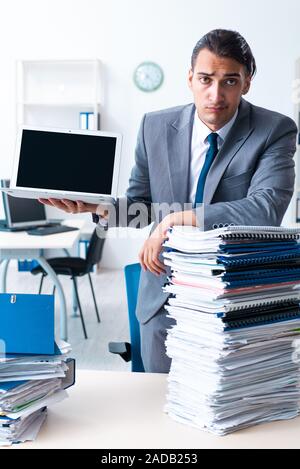 Businessman with heavy paperwork workload Stock Photo