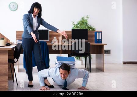 Male employee doing sport exercises in the office Stock Photo