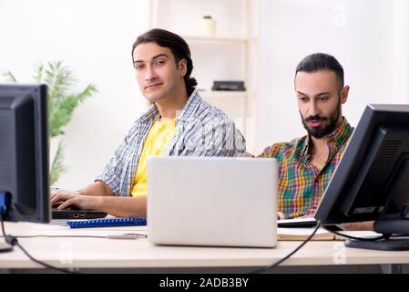 Two it specialists working in the office Stock Photo