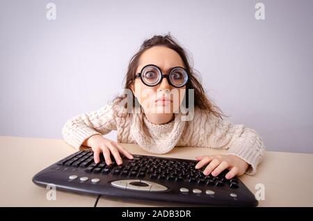 Funny nerd girl working on computer Stock Photo