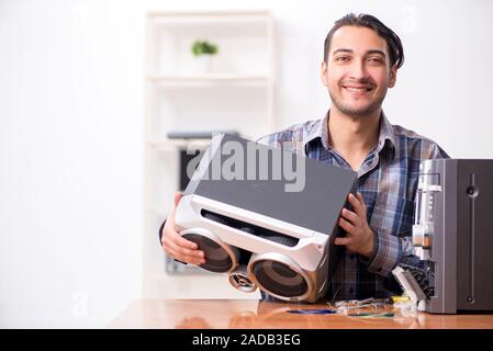 Young engineer repairing musical hi-fi system Stock Photo