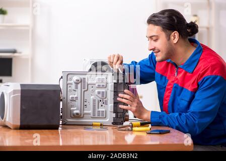 Young engineer repairing musical hi-fi system Stock Photo