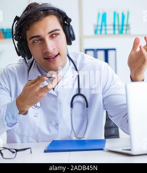 Male doctor listening to patient during telemedicine session Stock Photo