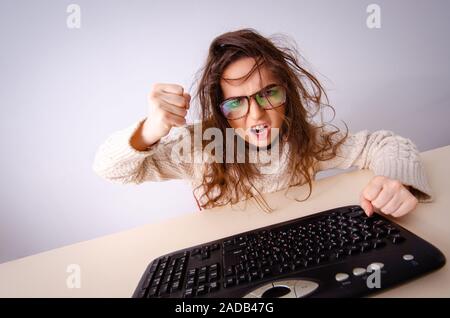 Funny nerd girl working on computer Stock Photo
