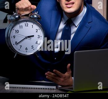 Businessman working overtime long hours late in office Stock Photo