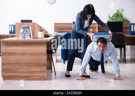 Male employee doing sport exercises in the office Stock Photo