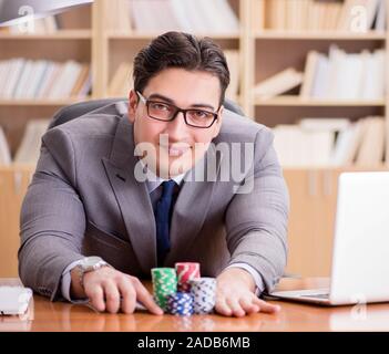 Businessman gambling playing cards at work Stock Photo