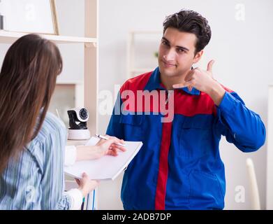 Client getting securty camera installed at home by contractor Stock Photo
