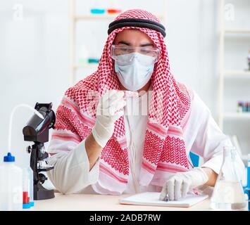 Arab doctor chemist studying new virus in lab Stock Photo