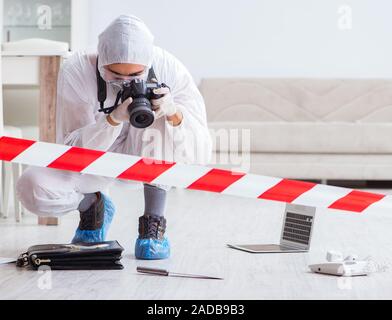 Forensic expert at crime scene doing investigation Stock Photo