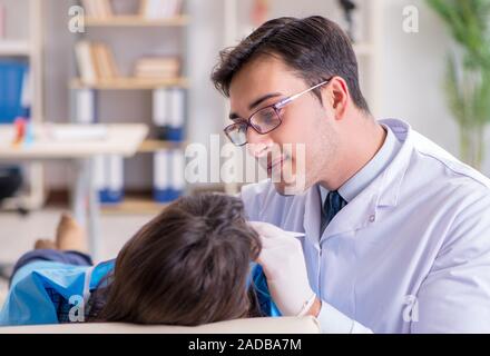 Patient visiting dentist for regular check-up and filling Stock Photo