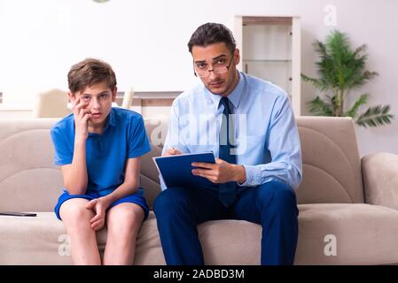 Internet addicted boy visiting male doctor Stock Photo